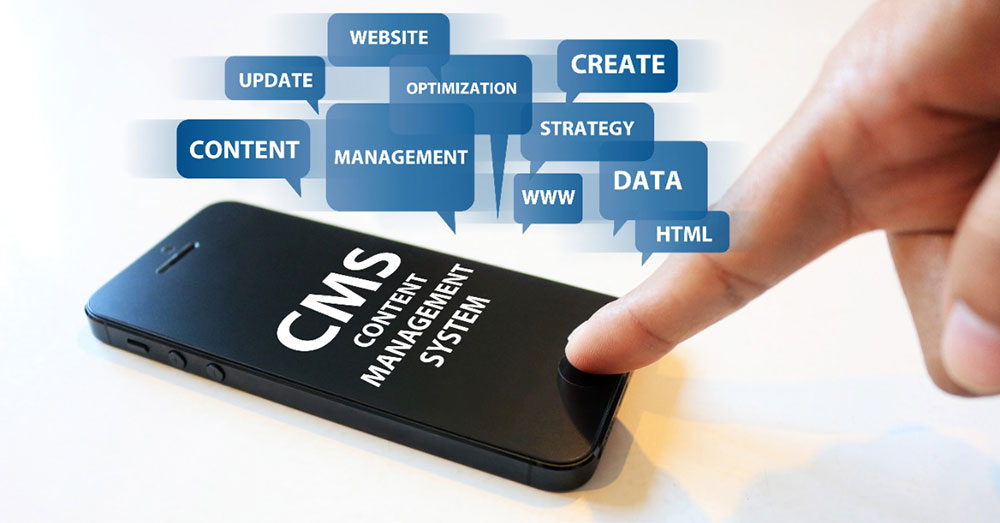 這張圖片展示了一隻手正在觸碰手機螢幕,手機上顯示「CMS (Content Management System)」字樣,周圍圍繞著與網站管理相關的詞語,如「CONTENT」、「WEBSITE」、「CREATE」、「UPDATE」等,象徵內容管理系統的功能和重要性。圖像強調了使用CMS進行網站管理的便捷性與多樣性。